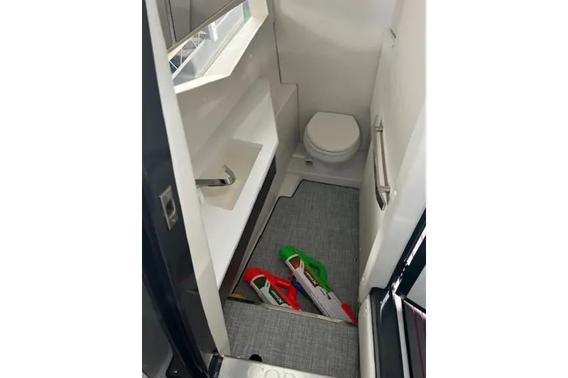 Slide: The Image of 2021 Cobalt A36BR boat bathroom interior with toilet, sink, and storage space. - 10