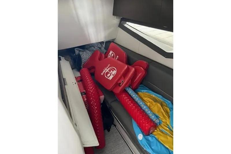 Slide: The Image of Interior of 2021 Cobalt A36BR boat with red life jackets and inflatables. - 13