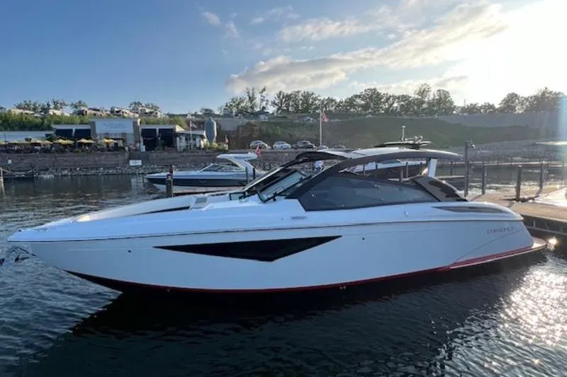Slide: The Image of 2021 Cobalt A36BR boat docked under a covered marina. - 4