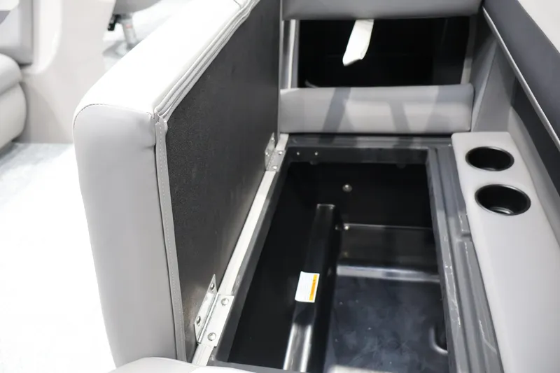Slide: The Image of Open storage compartment in 2026 Premier 200 Sunscape RF boat with cup holders. - 32