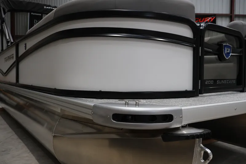 Slide: The Image of 2026 Premier 200 Sunscape RF pontoon boat, sleek design, docked indoors. - 6