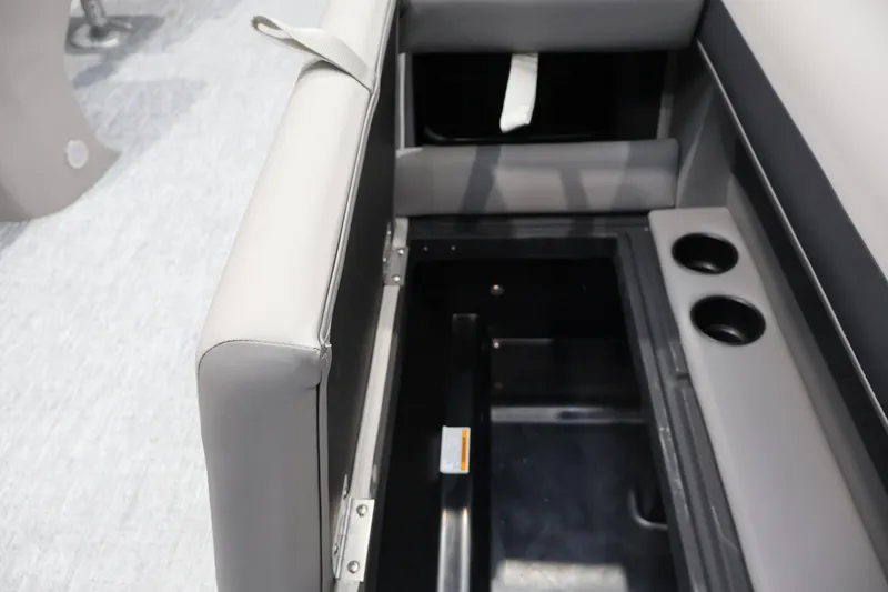 Slide: The Image of 2026 Premier 200 Sunscape RF boat seat storage with cup holders, showcasing interior features. - 16