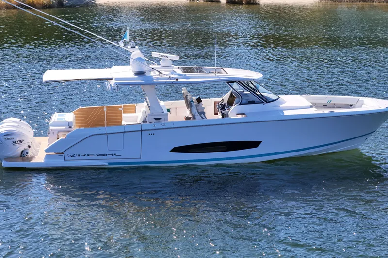 Slide: The Image of 2025 Regal 43 SAV boat on water, showcasing sleek design and modern features. - 10