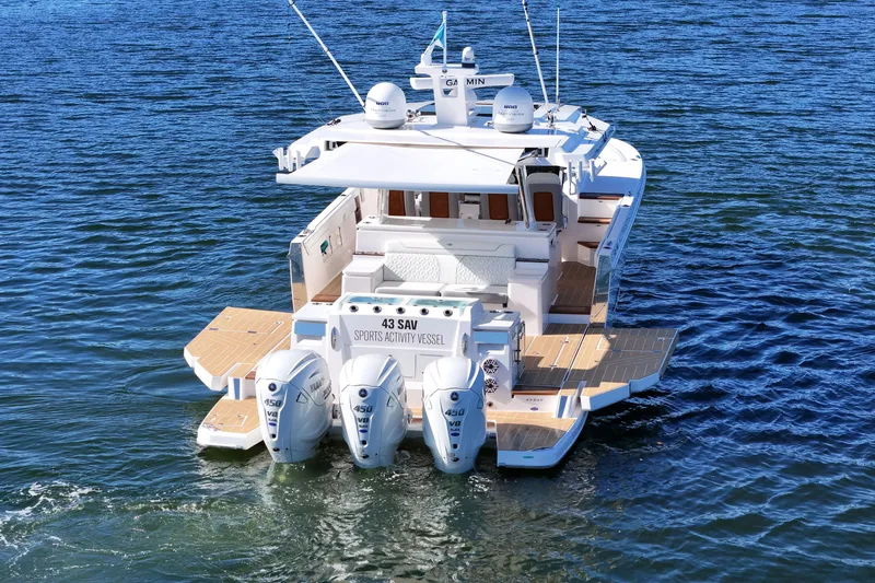 Slide: The Image of 2025 Regal 43 SAV sports activity vessel on water, featuring triple outboard engines. - 11