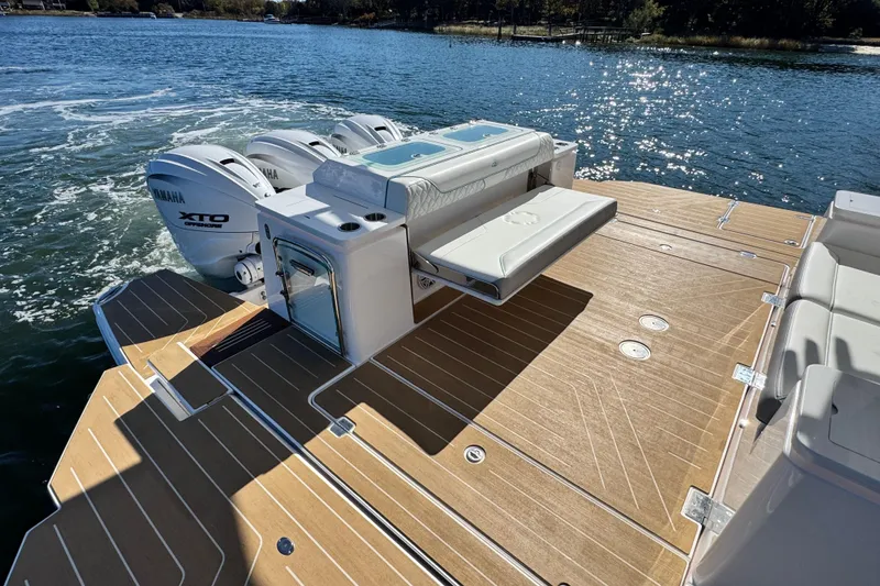 Slide: The Image of 2025 Regal 43 SAV boat with Yamaha XTO engines on a sunny lake. - 12