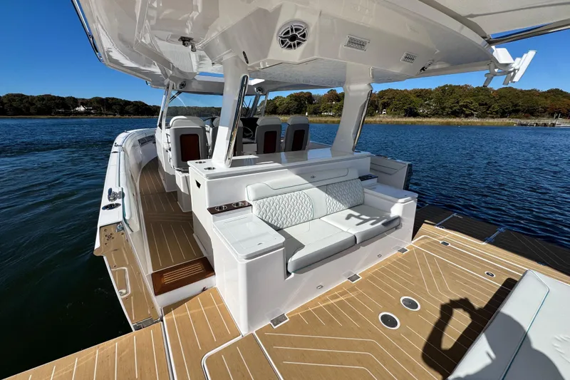 Slide: The Image of 2025 Regal 43 SAV luxury boat interior with seating, on a serene water backdrop. - 19