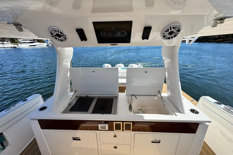 Slide: The Image of Luxury outdoor kitchen on 2025 Regal 43 SAV yacht with grill and sink. - 21