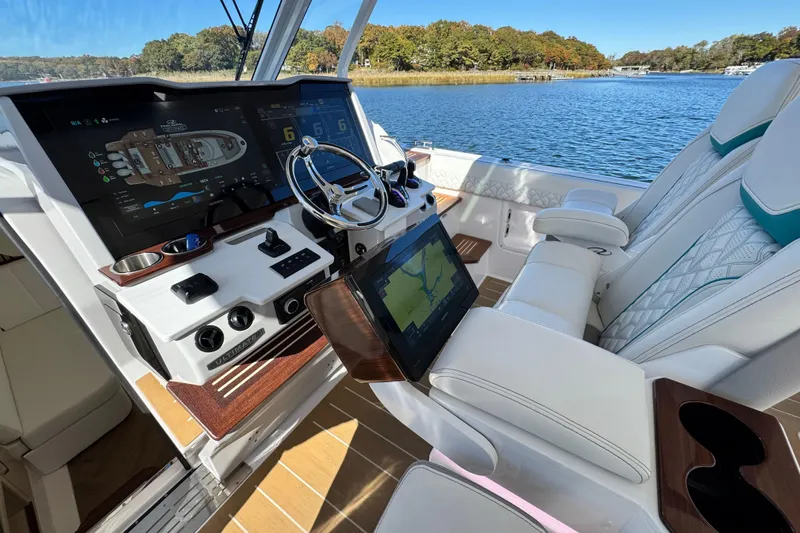 Slide: The Image of Helm of 2025 Regal 43 SAV yacht with advanced navigation displays and luxurious seating. - 27