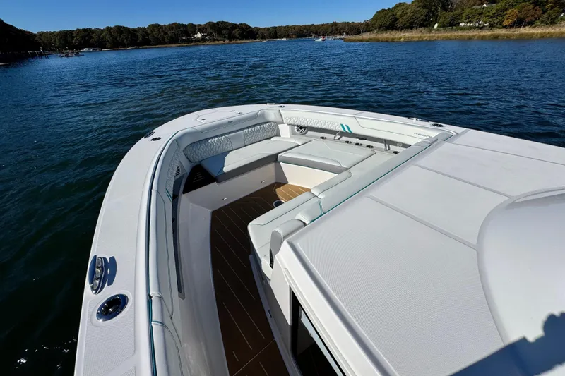 Slide: The Image of 2025 Regal 43 SAV boat with spacious seating on calm water. - 32