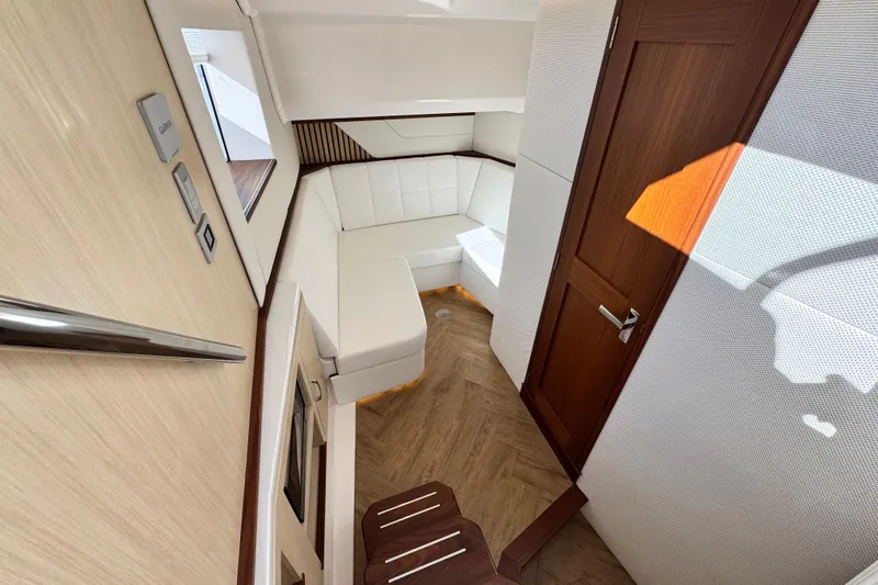 Slide: The Image of Luxurious interior of 2025 Regal 43 SAV yacht with white seating and wooden accents. - 37