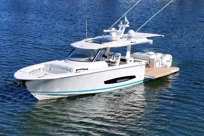 Slide: The Image of 2025 Regal 43 SAV luxury boat on calm blue water. - 4