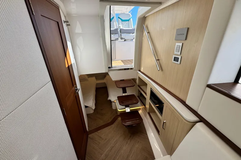 Slide: The Image of Luxurious interior of 2025 Regal 43 SAV yacht with modern wood finishes and seating area. - 40