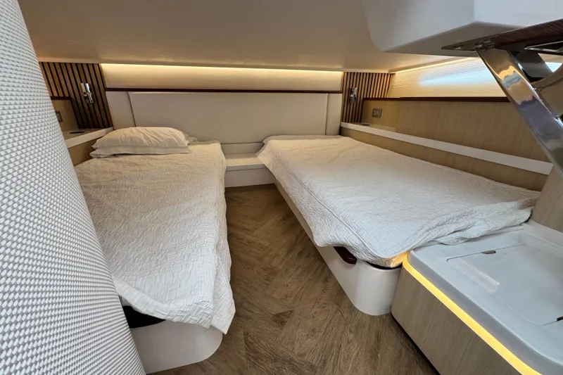 Slide: The Image of Luxurious cabin interior of 2025 Regal 43 SAV yacht with twin beds and modern design. - 41