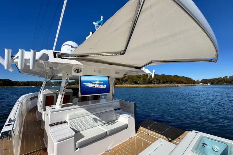 Slide: The Image of Luxurious 2025 Regal 43 SAV yacht with spacious deck and modern amenities on serene water. - 45