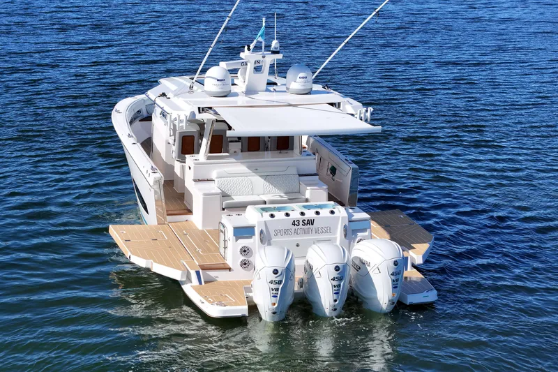 Slide: The Image of 2025 Regal 43 SAV boat on water, featuring triple Yamaha 450 V8 engines. - 7
