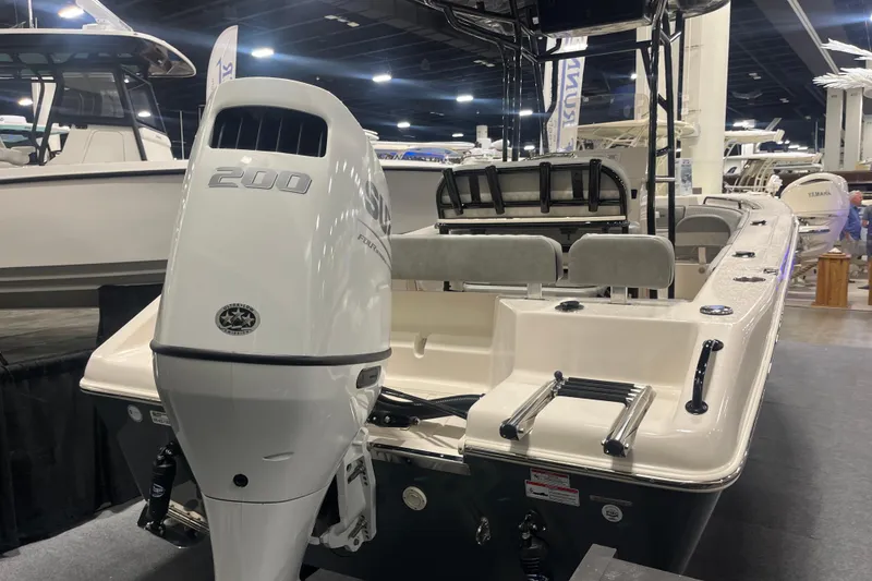 Slide: The Image of 2026 Sea Chaser 22 HFC boat with powerful 200 horsepower engine displayed indoors. - 3