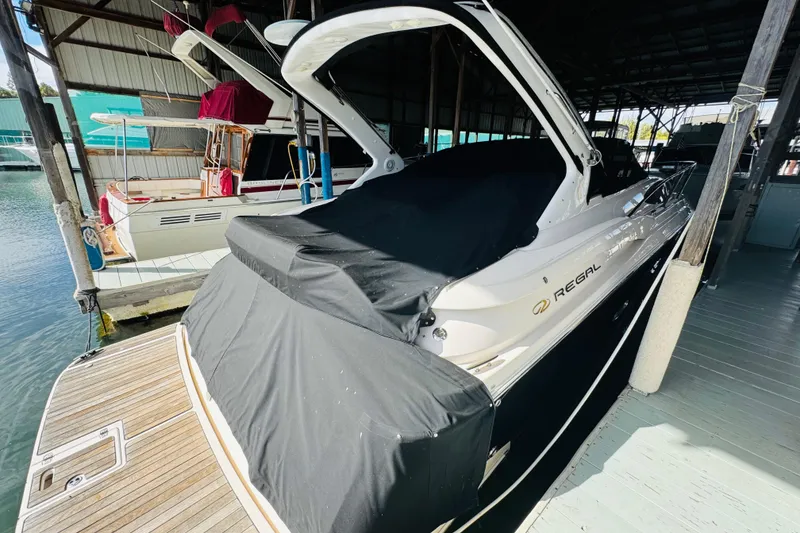 Slide: The Image of 2006 Regal 3360 Window Express boat docked in a covered marina. - 12