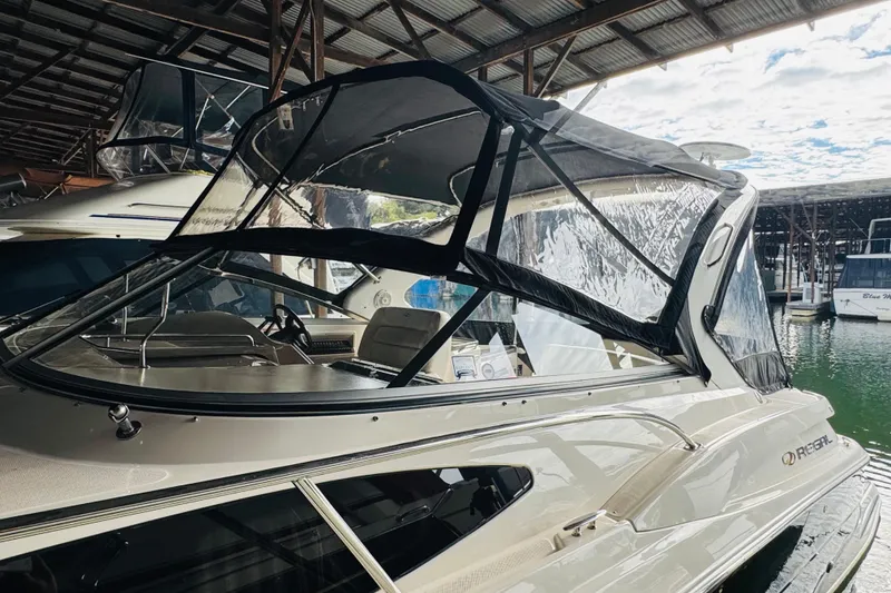 Slide: The Image of 2006 Regal 3360 Window Express boat docked under a covered marina. - 15