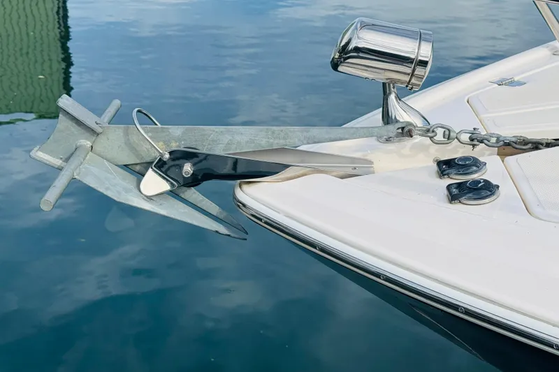 Slide: The Image of Anchor and chain on 2006 Regal 3360 Window Express boat, docked on calm water. - 18