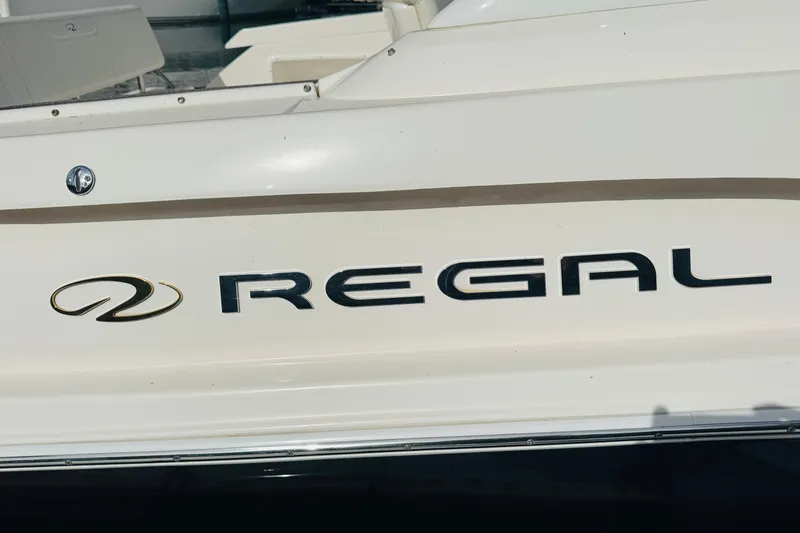 Slide: The Image of 2006 Regal 3360 Window Express boat logo on white hull. - 20