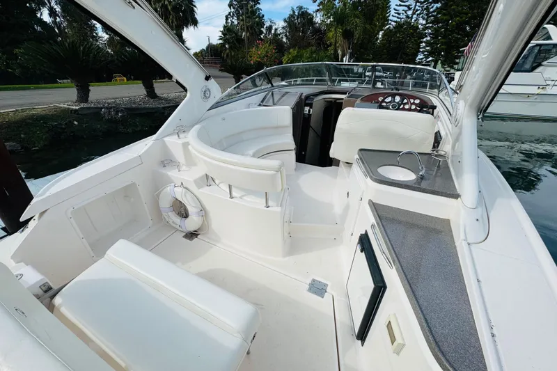 Slide: The Image of 2006 Regal 3360 Window Express boat interior with seating, sink, and steering wheel. - 28