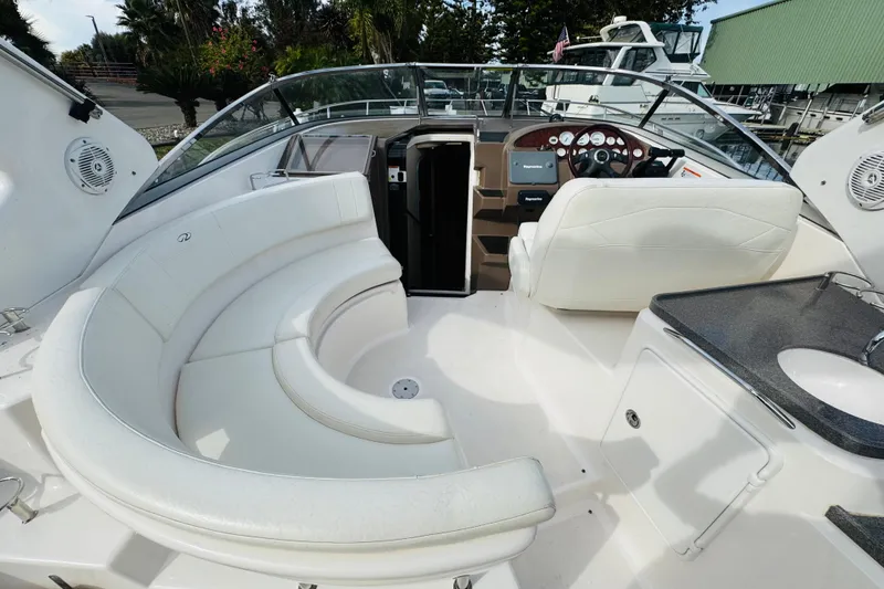 Slide: The Image of 2006 Regal 3360 Window Express boat interior with white seating and helm. - 29