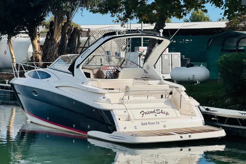 Slide: The Image of 2006 Regal 3360 Window Express boat docked, featuring sleek design and spacious deck. - 4