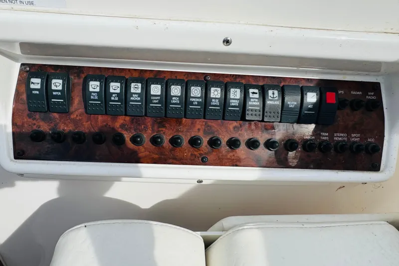 Slide: The Image of Control panel of a 2006 Regal 3360 Window Express boat with labeled switches. - 40