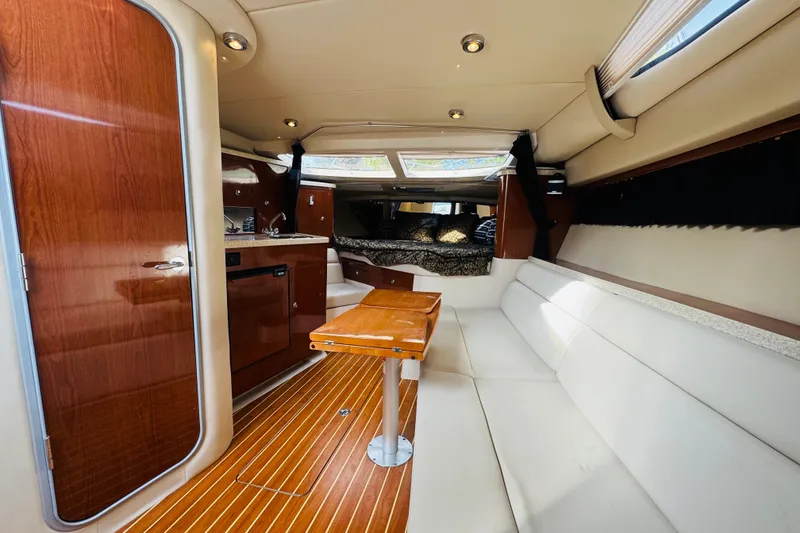 Slide: The Image of Interior of 2006 Regal 3360 Window Express yacht with wood accents and white seating. - 43