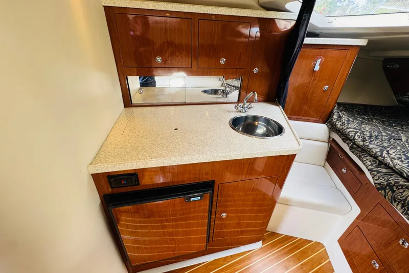 Slide: The Image of 2006 Regal 3360 Window Express cabin with kitchenette, sink, and wood cabinetry. - 47