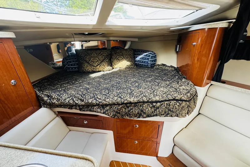 Slide: The Image of 2006 Regal 3360 Window Express cabin interior with bed and wooden cabinetry. - 50