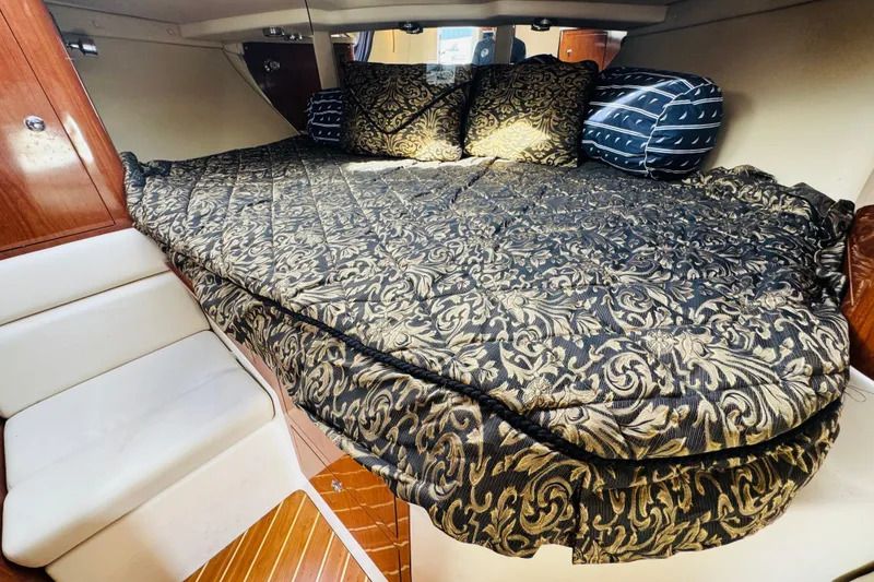 Slide: The Image of Luxurious cabin interior of 2006 Regal 3360 Window Express with ornate bedding and cushions. - 51