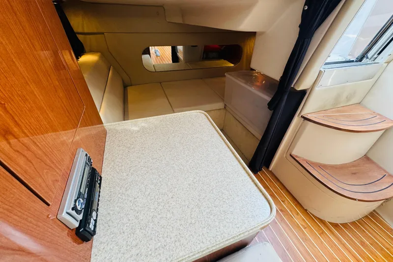 Slide: The Image of Interior of 2006 Regal 3360 Window Express yacht with wood accents and seating area. - 53