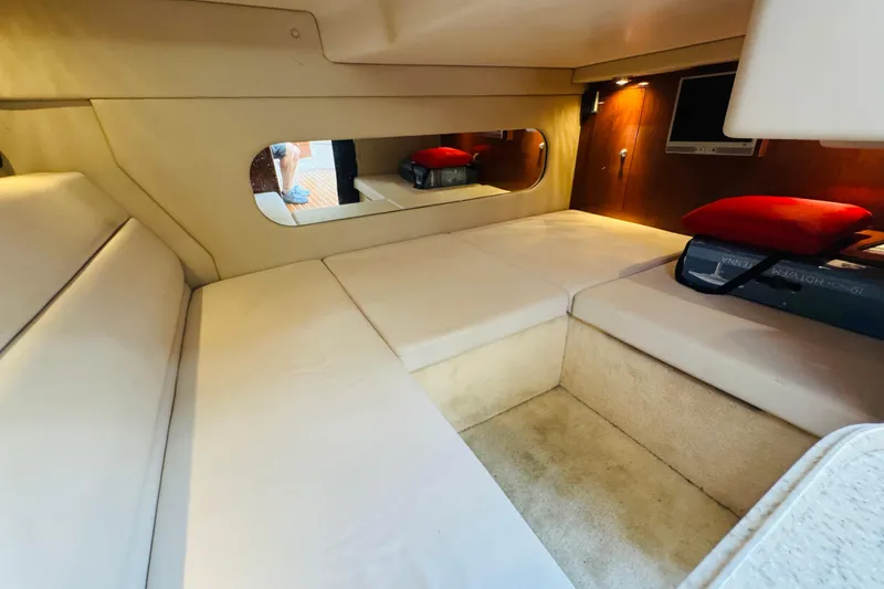 Slide: The Image of 2006 Regal 3360 Window Express cabin interior with beige seating and a wall-mounted TV. - 54