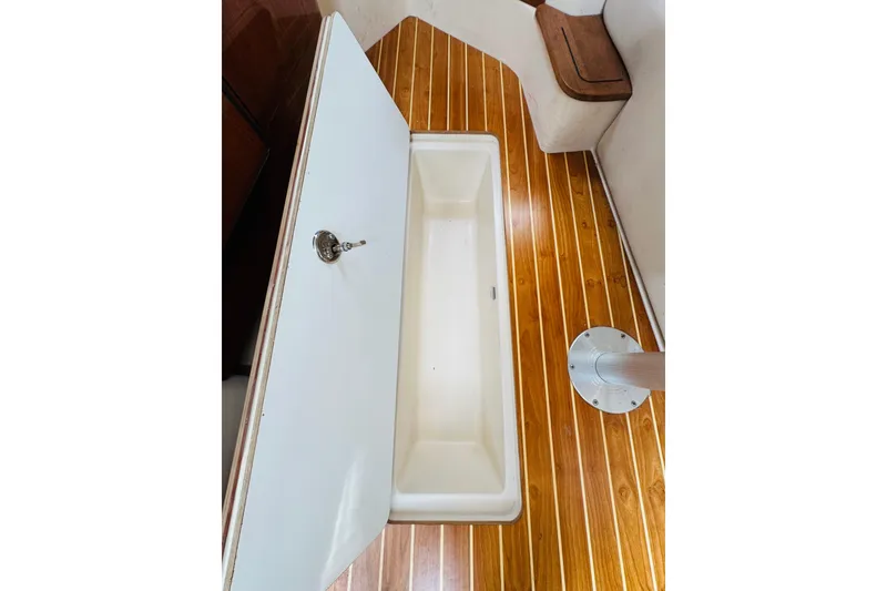 Slide: The Image of 2006 Regal 3360 Window Express interior with wooden flooring and storage compartment. - 58