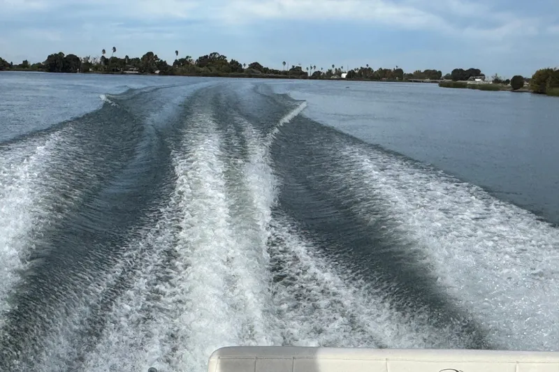 Slide: The Image of Wake trail from a 2006 Regal 3360 Window Express boat on a calm waterway. - 66