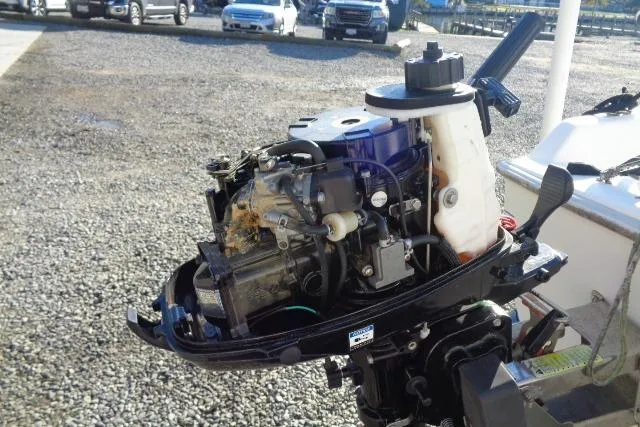 Slide: The Image of 2007 Sanibel 18 Pocket Cruiser outboard motor, detailed view in a parking lot. - 12