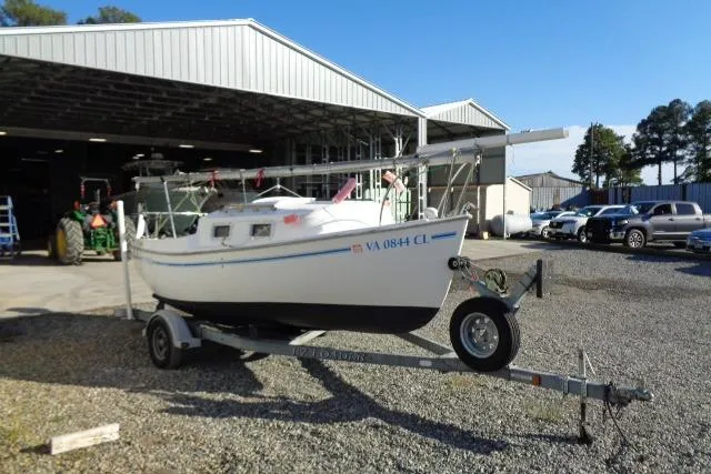 Slide: The Image of 2007 Sanibel by International Marine 18 Pocket Cruiser on trailer outside a warehouse. - 2