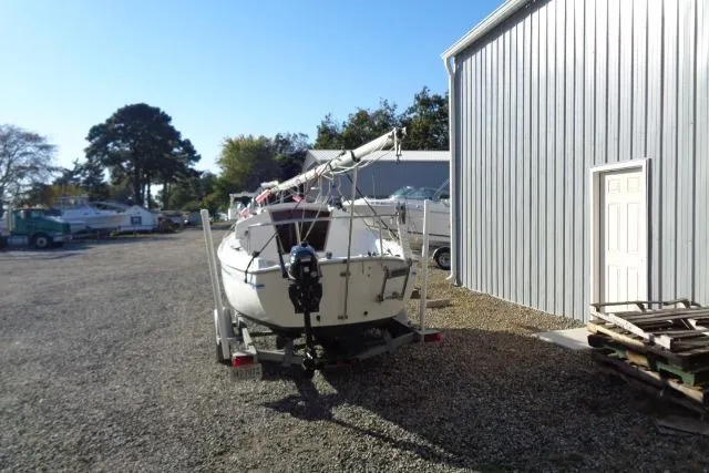 Slide: The Image of 2007 Sanibel by International Marine 18 Pocket Cruiser on trailer near metal building. - 7