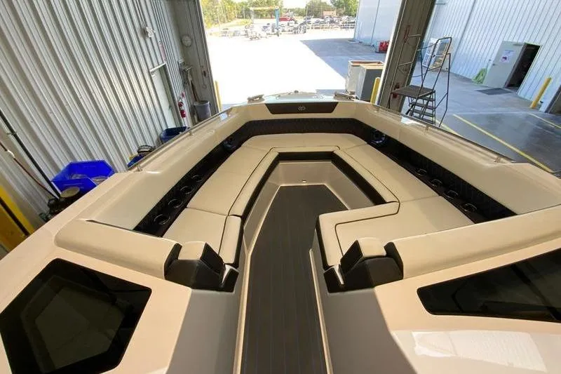 Slide: The Image of 2026 Cobalt R35 boat interior with sleek seating and modern design in a warehouse setting. - 22