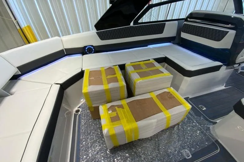 Slide: The Image of Interior of 2026 Cobalt R35 boat with packages on seating area. - 35