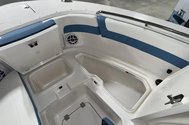 Slide: The Image of 2026 Robalo R257 Dual Console boat interior with storage compartments and seating. - 20