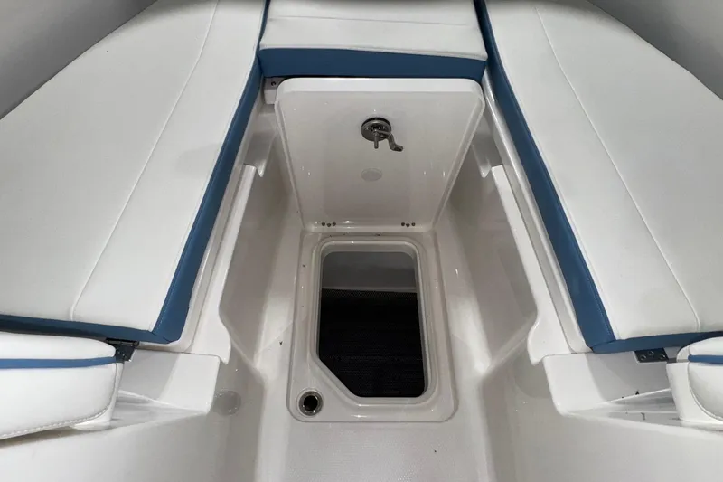 Slide: The Image of 2026 Robalo R257 Dual Console interior seating with storage compartment. - 21