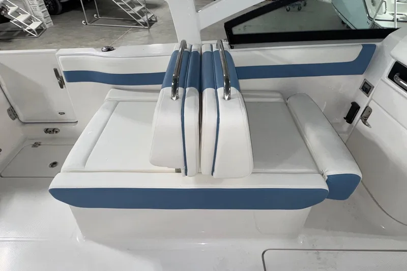 Slide: The Image of 2026 Robalo R257 Dual Console boat interior with blue and white seating. - 6