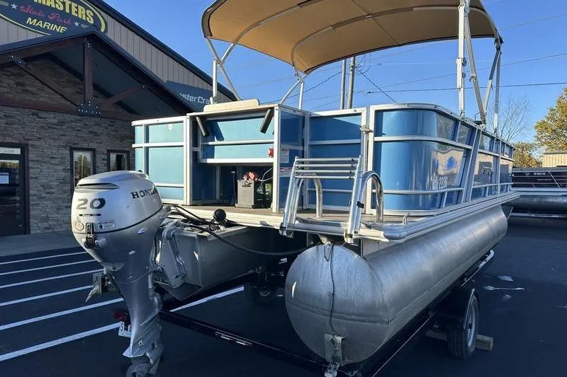 Slide: The Image of 2019 Starcraft EX 20 F4 pontoon boat with Honda 20 outboard motor, parked outside. - 1