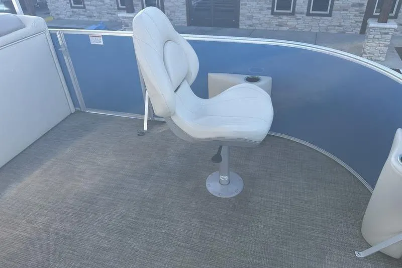 Slide: The Image of 2019 Starcraft EX 20 F4 boat interior with swivel seat and carpeted floor. - 10