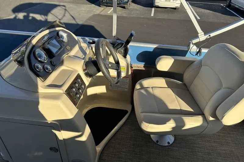 Slide: The Image of 2019 Starcraft EX 20 F4 boat interior with steering console and beige captain's chair. - 12