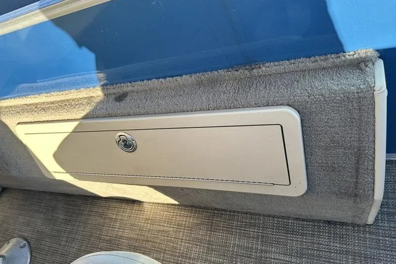 Slide: The Image of Interior storage compartment of 2019 Starcraft EX 20 F4 boat, featuring carpeted paneling. - 19