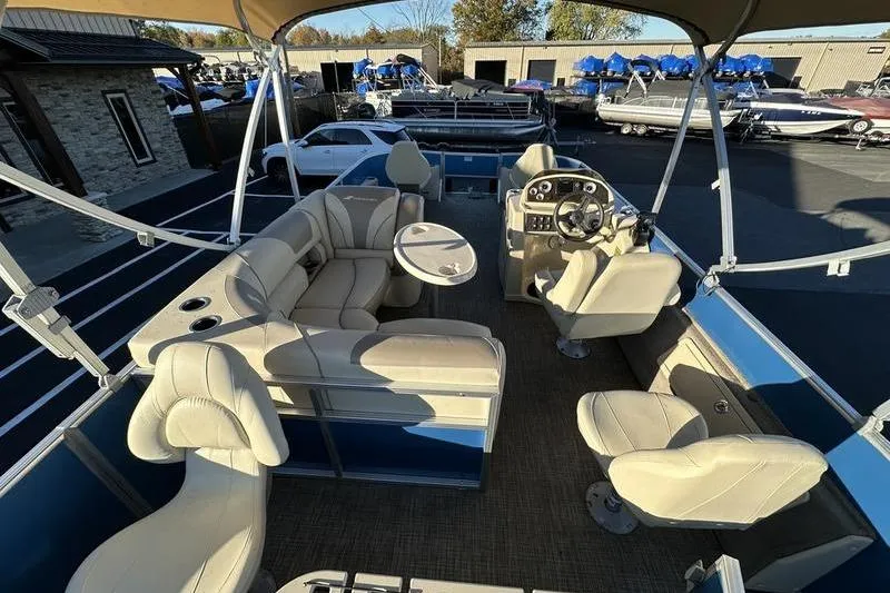 Slide: The Image of 2019 Starcraft EX 20 F4 pontoon boat with beige seating and steering console. - 2