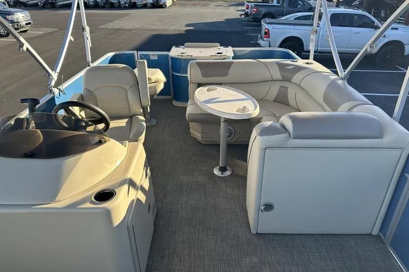 Slide: The Image of 2019 Starcraft EX 20 F4 pontoon boat interior with seating and steering console. - 20